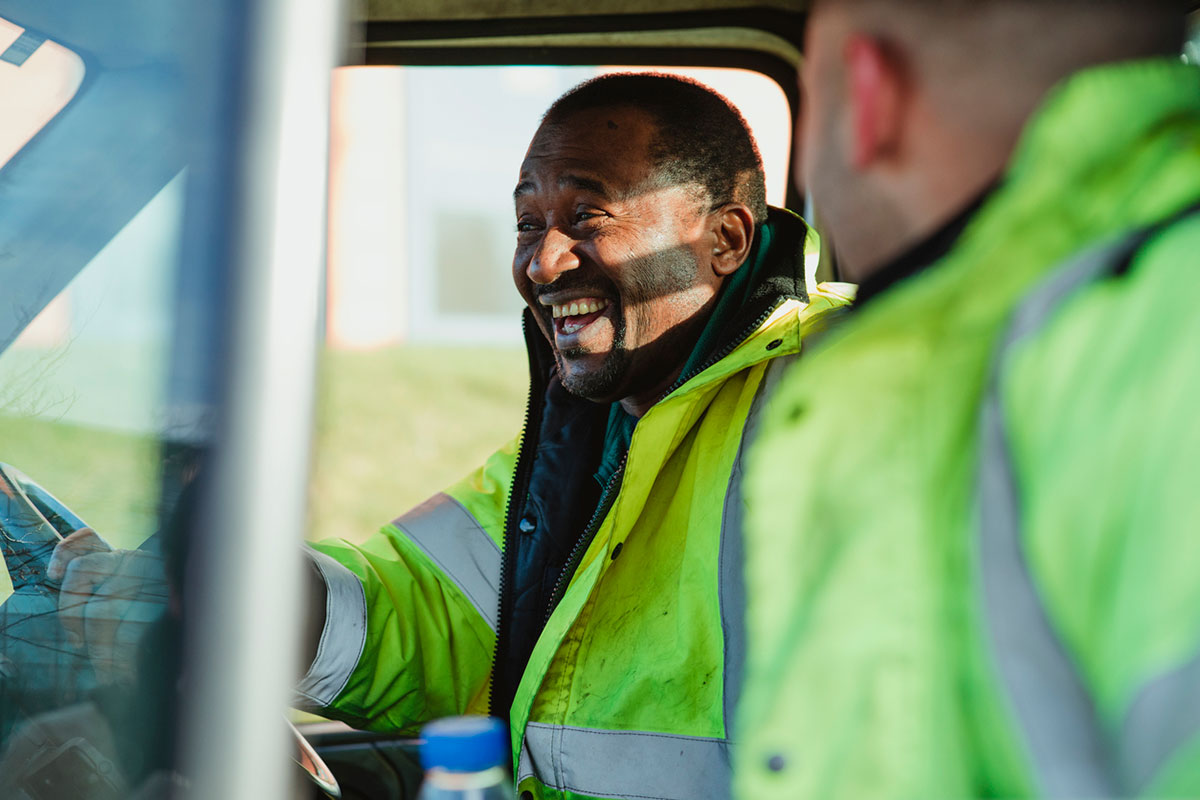 man in truck laughing with son 