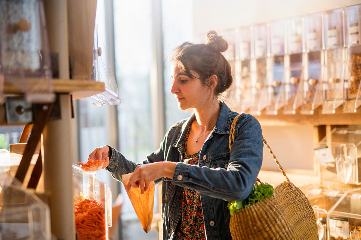 young woman shopping at bulk food store 